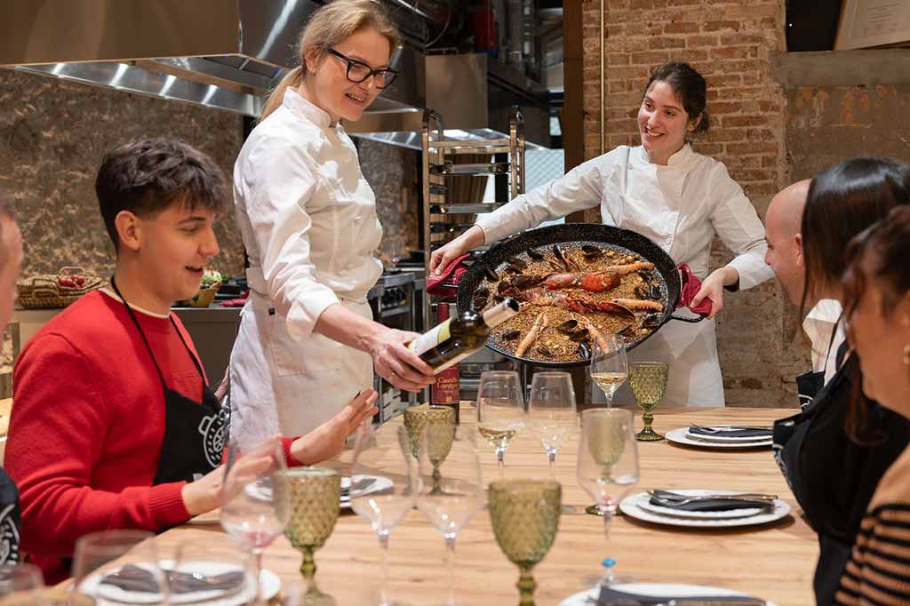 Private group of friends in a paella cooking class in Ciutat Vella, Barcelona.