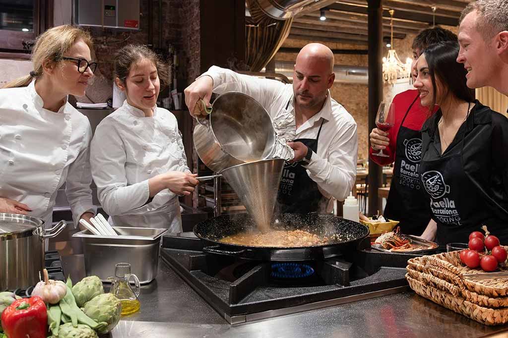migos y amigas en una despedida de soltero y solatera preparando una paella con chef en Barcelona